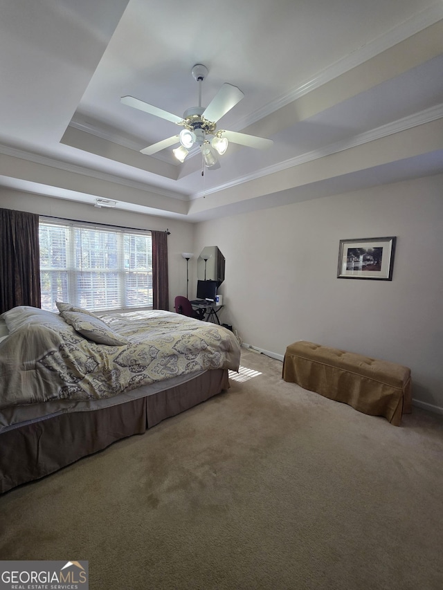 bedroom featuring carpet flooring, a raised ceiling, a ceiling fan, and crown molding