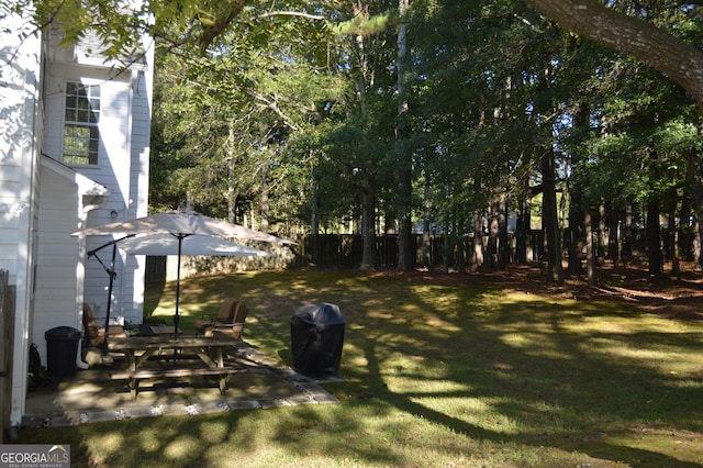 view of yard with fence and a patio