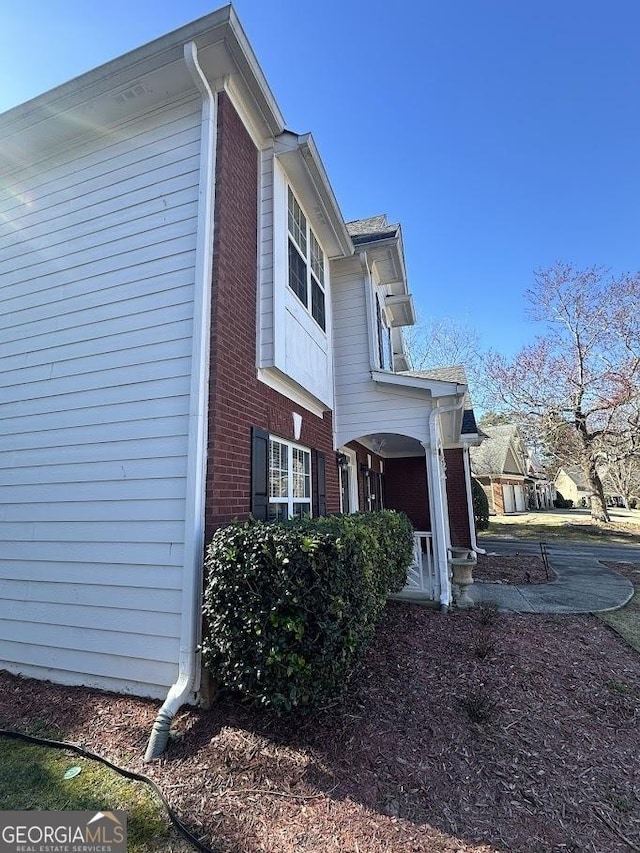 view of side of property with brick siding