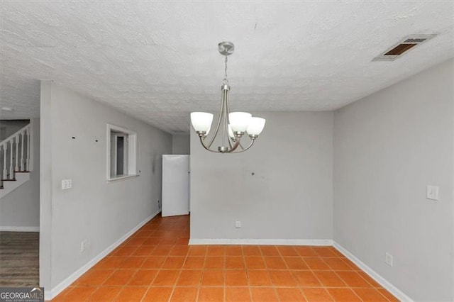 unfurnished room with baseboards, visible vents, stairs, a textured ceiling, and a chandelier