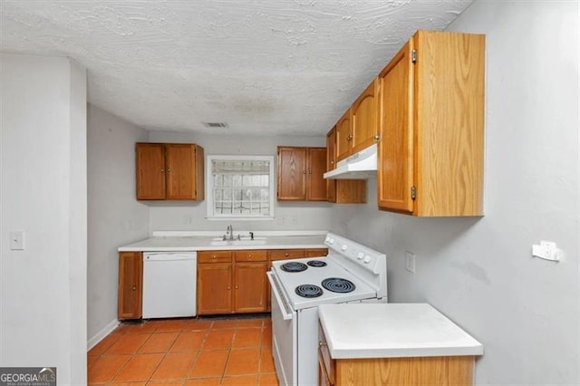 kitchen with white appliances, light countertops, a sink, and under cabinet range hood