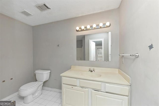 bathroom featuring visible vents, baseboards, toilet, tile patterned flooring, and vanity