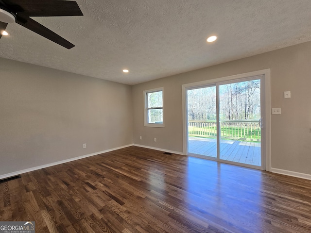 empty room with baseboards, dark wood finished floors, a ceiling fan, and recessed lighting