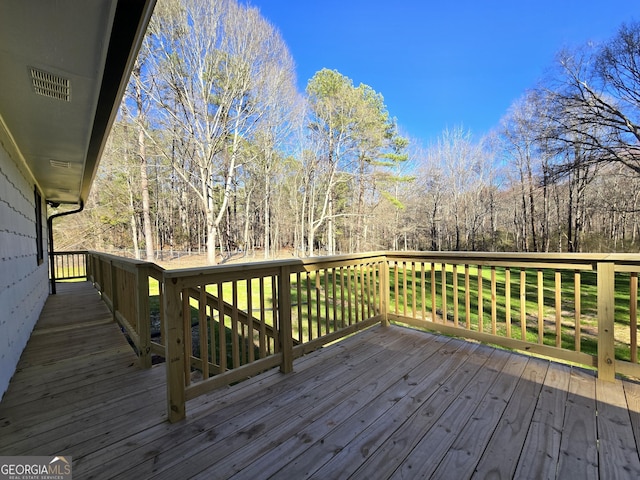 wooden terrace with a view of trees