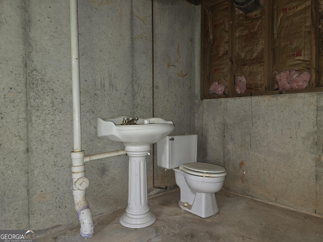 bathroom featuring toilet and unfinished concrete flooring