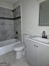 full bathroom with washtub / shower combination, vanity, and toilet