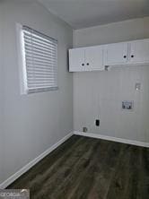 laundry area featuring cabinet space, hookup for a washing machine, baseboards, and dark wood-style flooring