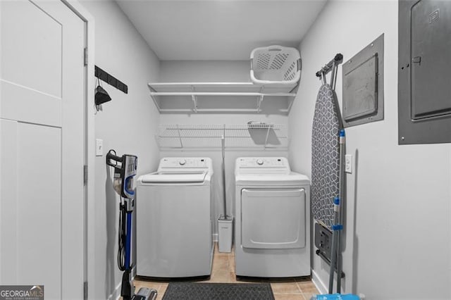 laundry room with laundry area, separate washer and dryer, and electric panel