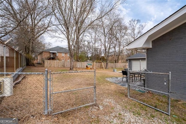 view of yard with a gate and a fenced backyard