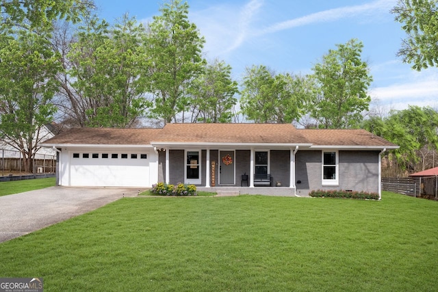 ranch-style home featuring a garage, fence, a front lawn, and concrete driveway