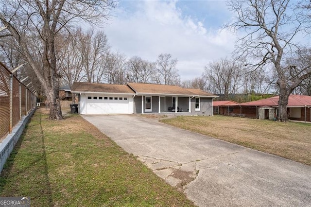 view of front facade with an attached garage, covered porch, fence, driveway, and a front lawn