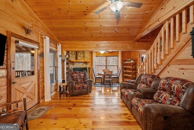 living room with vaulted ceiling, wood walls, wooden ceiling, and hardwood / wood-style flooring