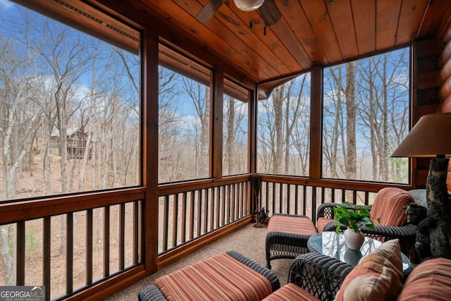 sunroom with wooden ceiling, a wealth of natural light, and a ceiling fan