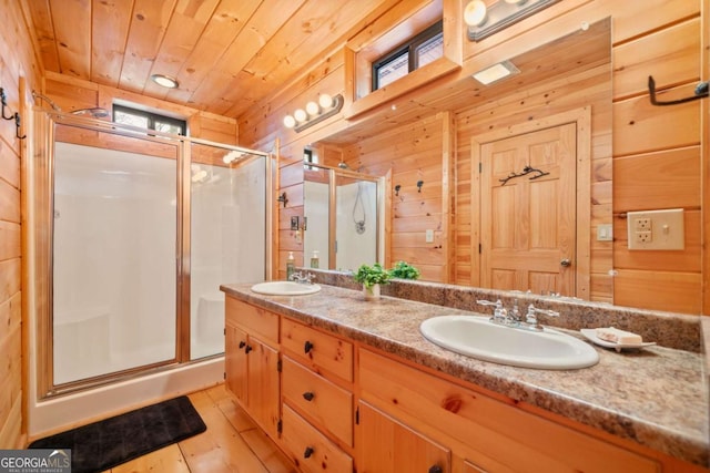 bathroom featuring a stall shower, wood ceiling, a sink, and wood walls