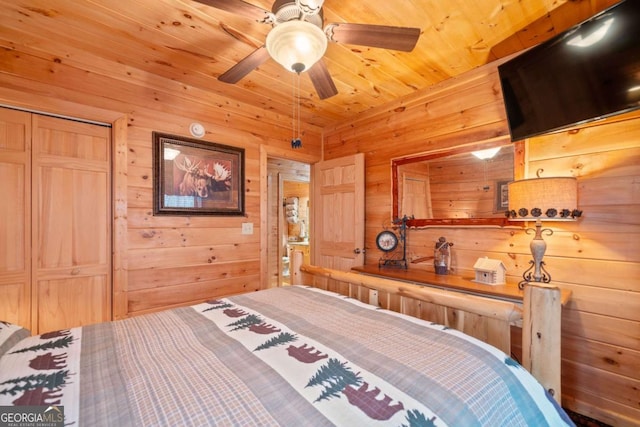 bedroom with a closet, wooden ceiling, and wooden walls