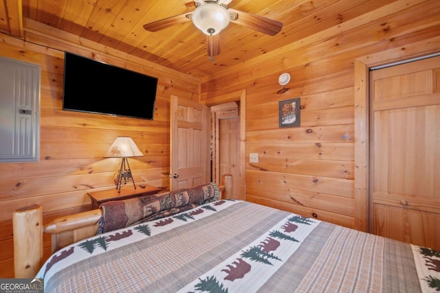 bedroom with a closet, wood ceiling, and wooden walls