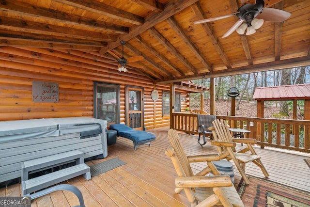 wooden deck with a ceiling fan and a hot tub