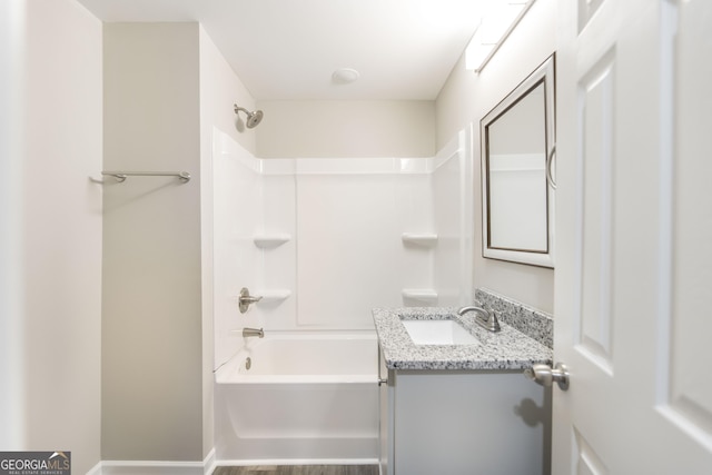 bathroom featuring shower / bathing tub combination, vanity, and baseboards