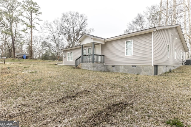 exterior space featuring a front yard, crawl space, and cooling unit