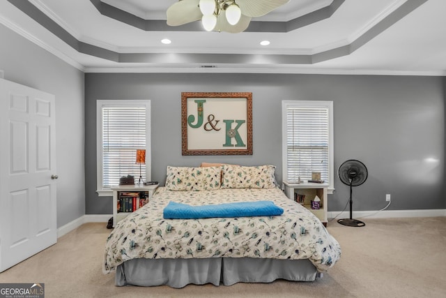 bedroom with light carpet, multiple windows, a raised ceiling, and crown molding