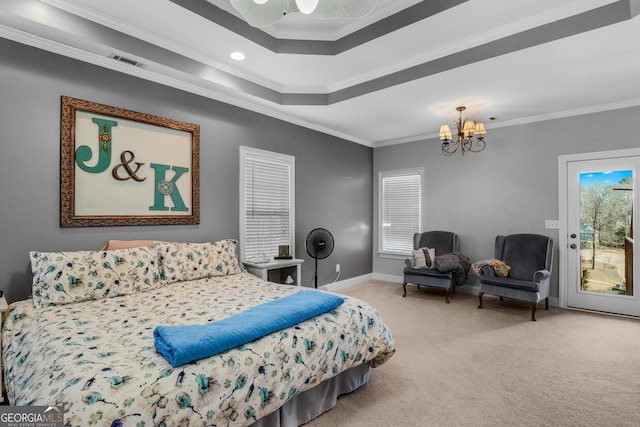 carpeted bedroom with a raised ceiling, visible vents, an inviting chandelier, ornamental molding, and access to outside