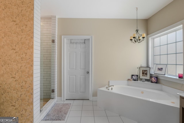 full bathroom with a stall shower, tile patterned flooring, a chandelier, and a bath