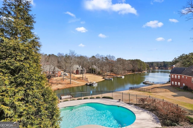 view of pool with a water view, fence, and a fenced in pool