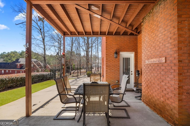 view of patio with outdoor dining area and fence