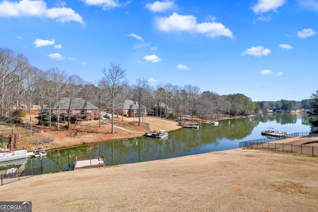 dock area featuring a water view and fence