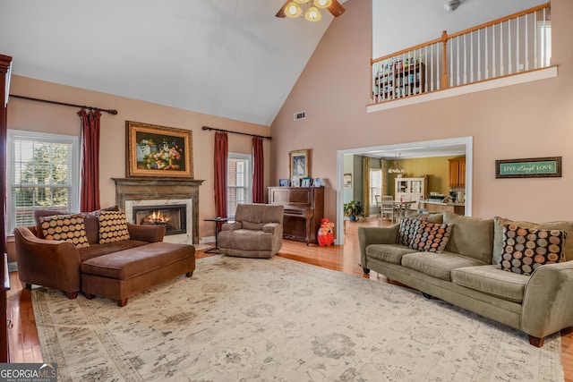 living room featuring plenty of natural light, a fireplace, and wood finished floors