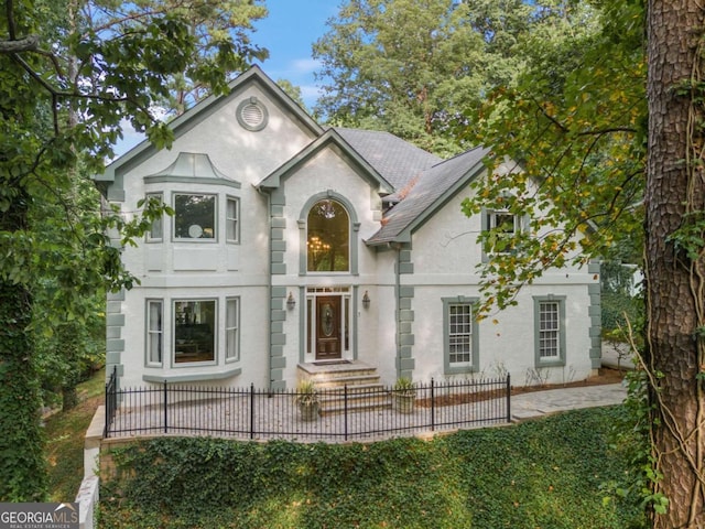 view of front of property with a fenced front yard and stucco siding