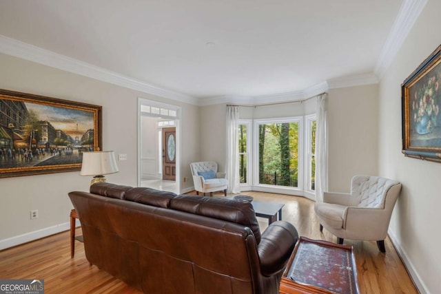 living area featuring baseboards, wood finished floors, and crown molding