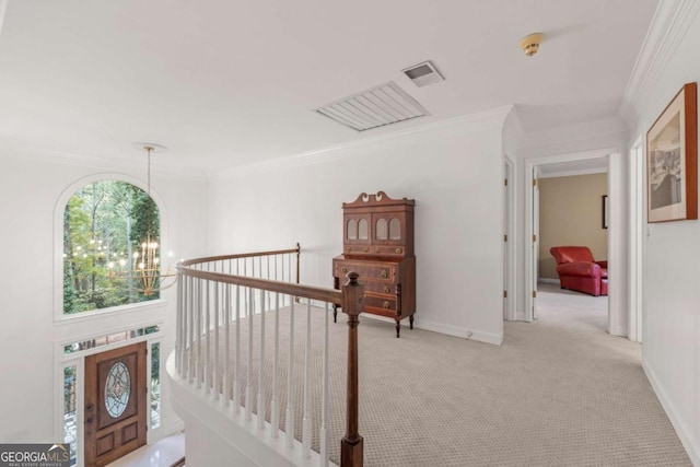 hallway featuring ornamental molding, light carpet, a notable chandelier, and baseboards