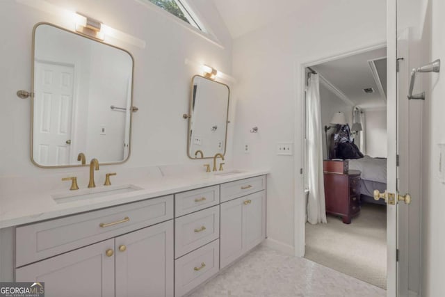 bathroom featuring double vanity, ensuite bath, vaulted ceiling, and a sink