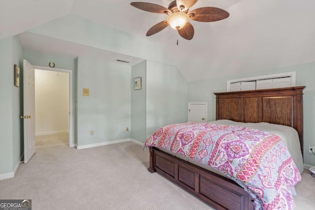 bedroom with light carpet, visible vents, baseboards, a ceiling fan, and lofted ceiling