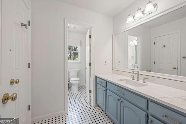 bathroom featuring toilet and vanity