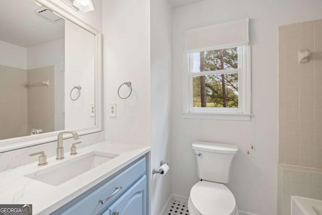 bathroom featuring toilet, baseboards, visible vents, and vanity