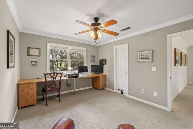 carpeted office featuring baseboards, a ceiling fan, visible vents, and crown molding