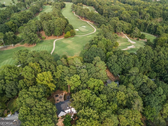 birds eye view of property with a forest view and golf course view