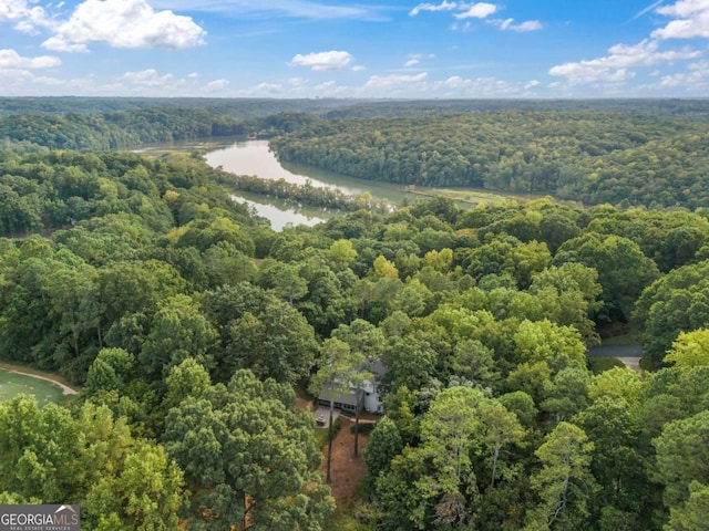 aerial view with a forest view and a water view