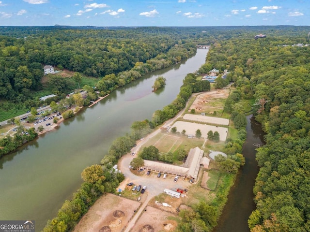 bird's eye view featuring a forest view and a water view