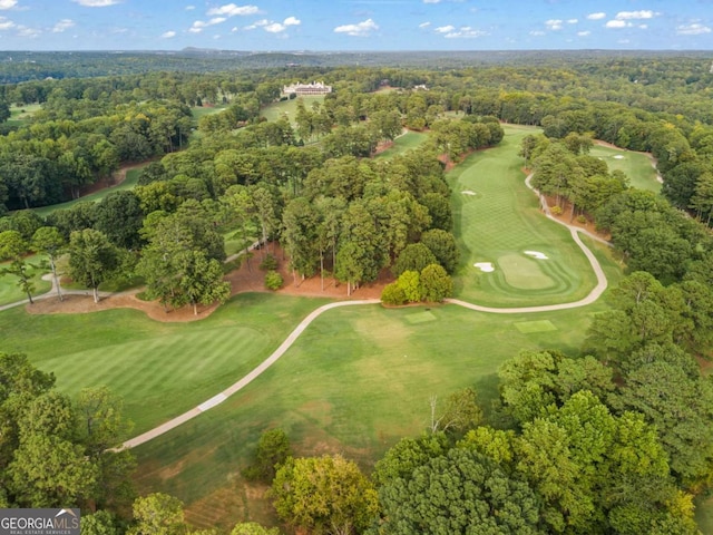 bird's eye view with a view of trees and golf course view