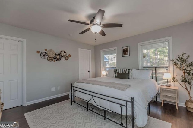 bedroom featuring a ceiling fan, baseboards, and wood finished floors