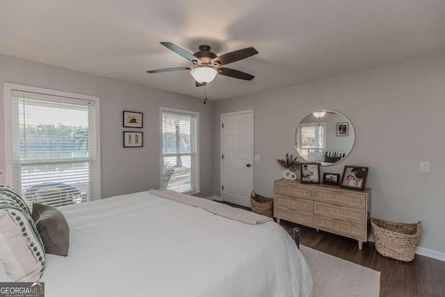 bedroom featuring ceiling fan, wood finished floors, and baseboards