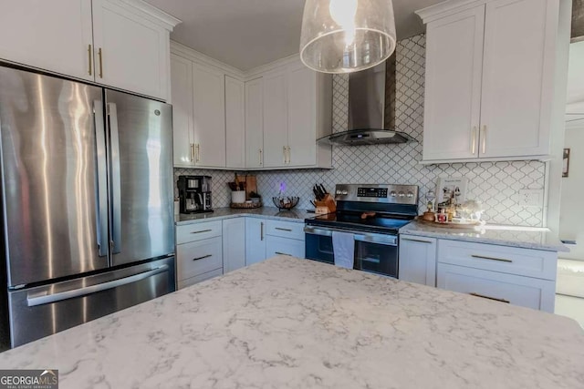 kitchen with stainless steel appliances, light stone counters, wall chimney exhaust hood, and tasteful backsplash