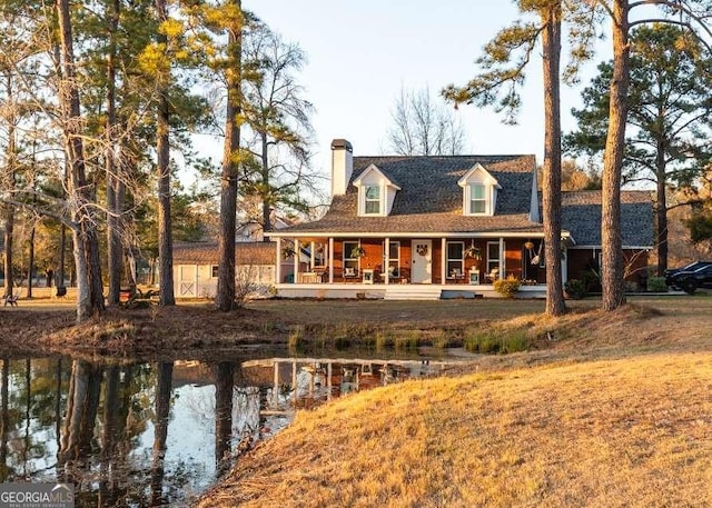 rear view of property featuring covered porch