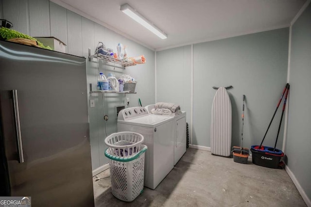 clothes washing area featuring laundry area and washer and clothes dryer