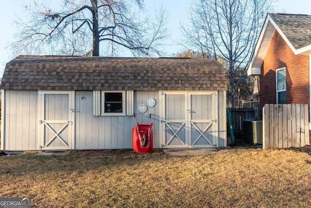 view of shed featuring fence