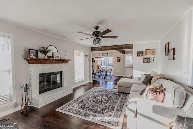 living room featuring crown molding, a fireplace, a ceiling fan, and wood finished floors