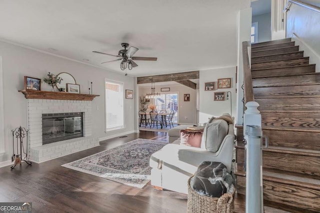 living room featuring ceiling fan, a fireplace, wood finished floors, baseboards, and stairway